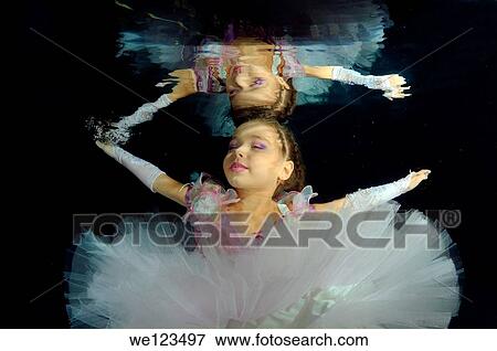 Girl presenting underwater fashion in pool View Large Photo Image Stock Photo - Girl presenting underwater fashion in pool. Fotosearch
