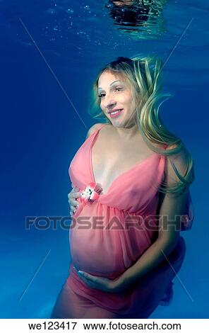 pregnant woman, underwater fashion in a pool View Large Photo Image Stock Photo - pregnant woman, underwater fashion in a pool. Fotosearch