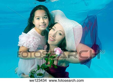 Woman and girl, underwater models, presenting fashion in pool View Large Photo Image Picture - Woman and girl, underwater models, presenting fashion in pool. Fotosearch