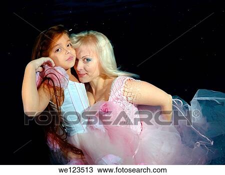 Woman and girl, underwater models, presenting fashion in pool View Large Photo Image Stock Image - Woman and girl, underwater models, presenting fashion in pool. Fotosearch