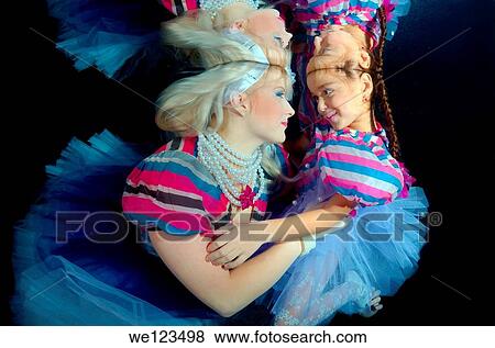 Woman and girl, underwater models, presenting fashion in pool View Large Photo Image Stock Photo - Woman and girl, underwater models, presenting fashion in pool. Fotosearch