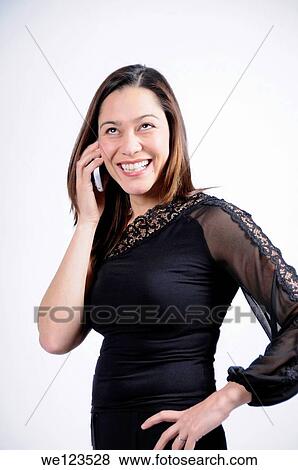 Woman dressed in black talking on the telephone and seems very happy She is of mixed ethnicity View Large Photo Image Stock Photo - Woman dressed in black talking on the telephone and seems very happy She is of mixed ethnicity. Fotosearch