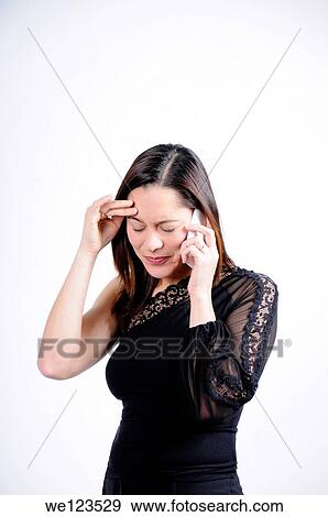 Woman dressed in black talking on the telephone and seems very sad and holding her head She is of mixed ethnicity View Large Photo Image Stock Photo - Woman dressed in black talking on the telephone and seems very sad and holding her head She is of mixed ethnicity. Fotosearch