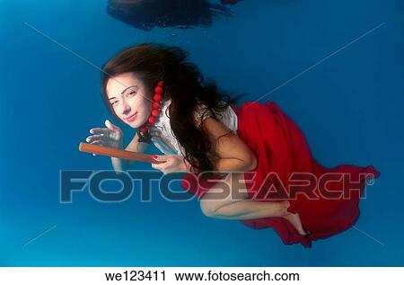 Woman presenting underwater fashion in a pool View Large Photo Image Stock Image - Woman presenting underwater fashion in a pool. Fotosearch