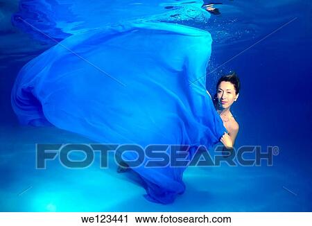 Woman presenting underwater fashion in a pool View Large Photo Image Stock Image - Woman presenting underwater fashion in a pool. Fotosearch