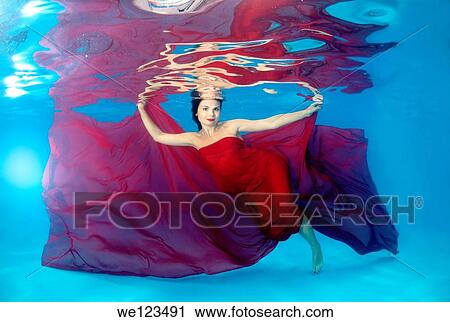 Woman presenting underwater fashion in a pool View Large Photo Image Stock Image - Woman presenting underwater fashion in a pool. Fotosearch