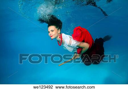 Woman presenting underwater fashion in a pool View Large Photo Image Stock Image - Woman presenting underwater fashion in a pool. Fotosearch