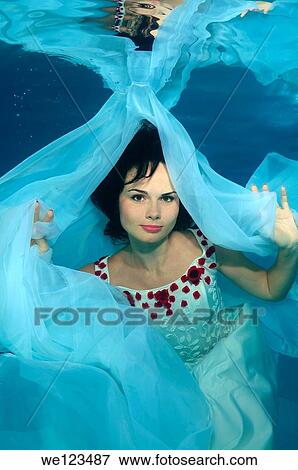 Woman presenting underwater fashion in a pool View Large Photo Image Stock Photo - Woman presenting underwater fashion in a pool. Fotosearch
