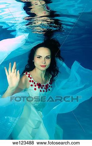 Woman presenting underwater fashion in a pool View Large Photo Image Stock Photo - Woman presenting underwater fashion in a pool. Fotosearch