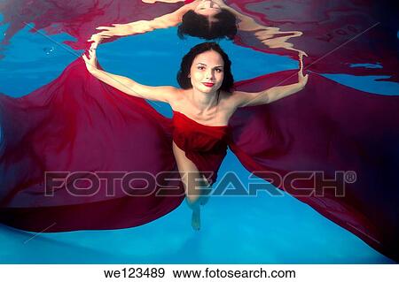 Woman presenting underwater fashion in a pool View Large Photo Image Stock Photo - Woman presenting underwater fashion in a pool. Fotosearch