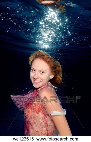Woman presenting underwater fashion in a pool View Large Photo Image Stock Photography - Woman presenting underwater fashion in a pool. Fotosearch