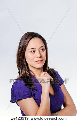 Women looking sideways with her arm up and wearing a blue dress She is a mixed race View Large Photo Image Stock Photo - Women looking sideways with her arm up and wearing a blue dress She is a mixed race. Fotosearch