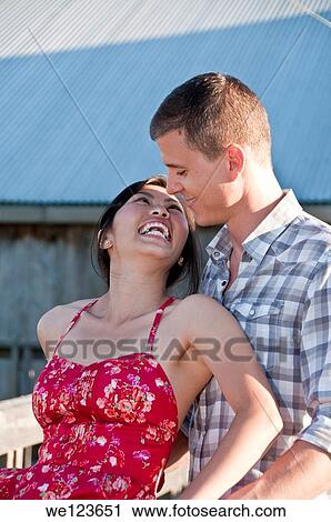 Young asian girl looking up a young man. View Large Photo Image Stock Image - Young asian girl looking up a young man.. Fotosearch