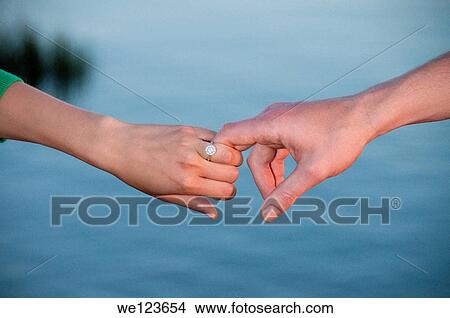 Picture - Young couple holding hands. Fotosearch