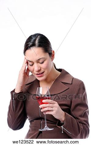 Stock Image - Young filipino women has her hand holding her head as if she has headache. Fotosearch