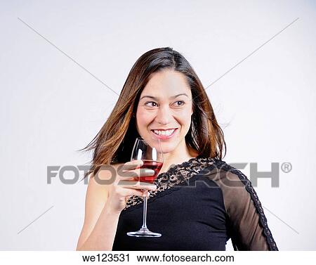 Young lady holding a glass of wine and a big smile She is of mixed ethnicity View Large Photo Image Stock Image - Young lady holding a glass of wine and a big smile She is of mixed ethnicity. Fotosearch