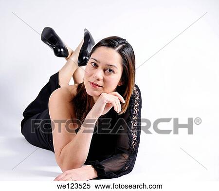 Young woman of filipino ethnicity laying on a white background She has her head resting against her hand View Large Photo Image Stock Photography - Young woman of filipino ethnicity laying on a white background She has her head resting against her hand. Fotosearch
