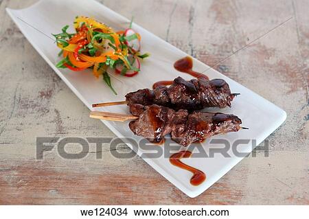 Picture - Beef Teriyaki skewers (Guyniku) with vegetables.. Fotosearch