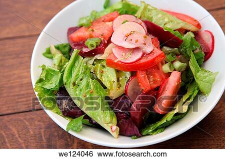 Stock Photograph - Green salad with lettuce, rocket (Arugula) beetroot and tomatoes.. Fotosearch