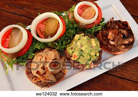 Three mini hamburgers with onions, guacamole and mushrooms. View Large Photo Image Stock Image - Three mini hamburgers with onions, guacamole and mushrooms.. Fotosearch