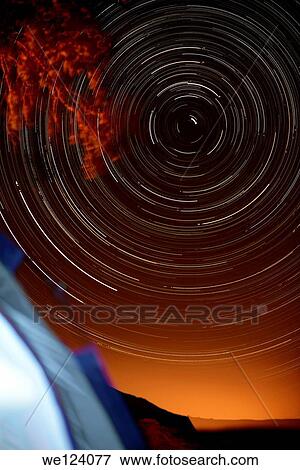Time-exposure of polar star trails. The Pole Star, Polaris, is the short bright trail just off centre. The circular formation of the star trails is a result of the Earth's revolution in relation to the fixed stars. The different colours of the star trails View Large Photo Image Stock Photo - Time-exposure of polar star trails. The Pole Star, Polaris, is the short bright trail just off centre. The circular formation of the star trails is a result of the Earth's revolution in relation to the fixed stars. The different colours of the star trails. Fotosearch