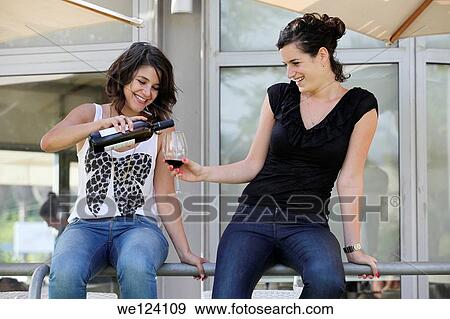 Two friend enjoy a glass of wine outdoors. View Large Photo Image Stock Photo - Two friend enjoy a glass of wine outdoors.. Fotosearch