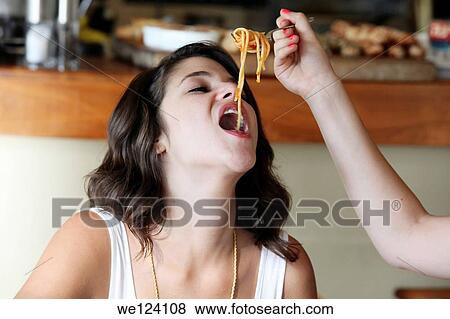 two friends eat spaghetti View Large Photo Image Stock Photo - two friends eat spaghetti. Fotosearch
