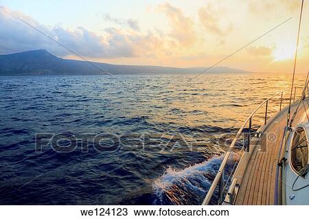Yacht sailing at sunset along Akamas peninsula, Cyprus. View Large Photo Image Stock Image - Yacht sailing at sunset along Akamas peninsula, Cyprus.. Fotosearch