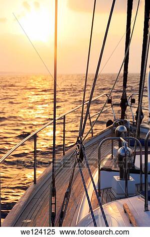 Yacht sailing at sunset along Akamas peninsula, Cyprus. View Large Photo Image Stock Photography - Yacht sailing at sunset along Akamas peninsula, Cyprus.. Fotosearch