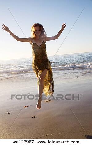 Young Woman Celebrating On Beach. View Large Photo Image Stock Photo - Young Woman Celebrating On Beach.. Fotosearch