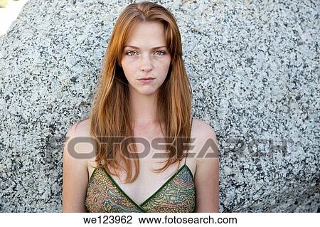 Stock Image - Young Woman On Beach Against Rock.. Fotosearch