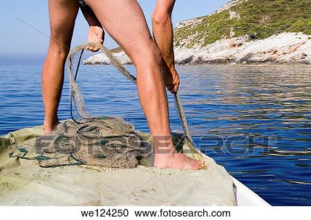 Adriatic Sea at the Vis bay. Pulling small fishing nets. View Large Photo Image Stock Image - Adriatic Sea at the Vis bay. Pulling small fishing nets.. Fotosearch