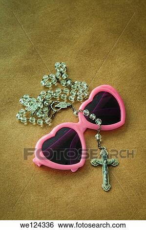 Crucifix on a pair of heart-shaped sunglasses. View Large Photo Image Stock Photograph - Crucifix on a pair of heart-shaped sunglasses.. Fotosearch