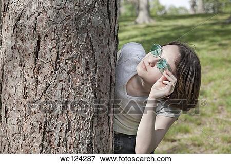 Eurasian teenage girl at a park wearing green sunglasses. View Large Photo Image Stock Photo - Eurasian teenage girl at a park wearing green sunglasses.. Fotosearch
