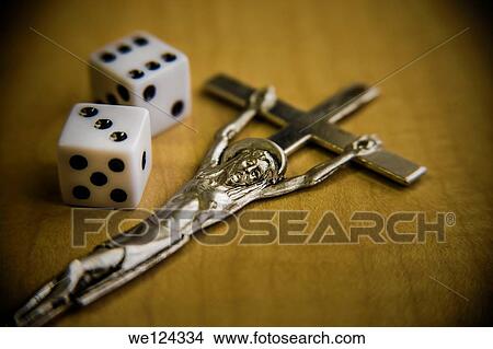 Picture - Pair of dice next to a crucifix.. Fotosearch