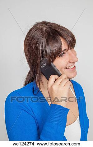 Picture - Teen girl talking on a smart phone.. Fotosearch