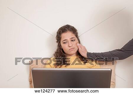 Stock Photo - Teen girl, with her laptop computer, and her mother's arm.. Fotosearch