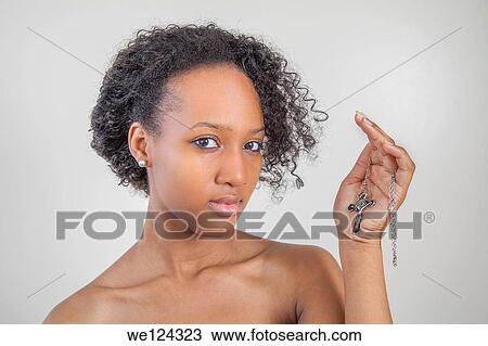 Young black woman holding a crucifix. View Large Photo Image Stock Image - Young black woman holding a crucifix.. Fotosearch