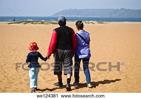 Young family walking on the beach, Goa, India. View Large Photo Image Stock Image - Young family walking on the beach, Goa, India.. Fotosearch