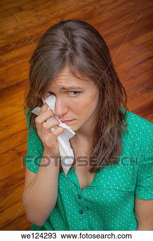 Young woman, sitting on the floor, with a tissue. View Large Photo Image Stock Image - Young woman, sitting on the floor, with a tissue.. Fotosearch