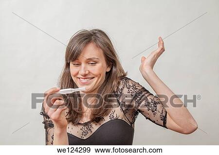 Young woman with a pregnancy tester. View Large Photo Image Stock Photo - Young woman with a pregnancy tester.. Fotosearch