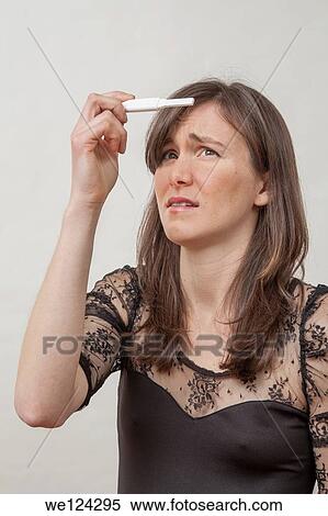 Young woman with a pregnancy tester. View Large Photo Image Stock Photography - Young woman with a pregnancy tester.. Fotosearch