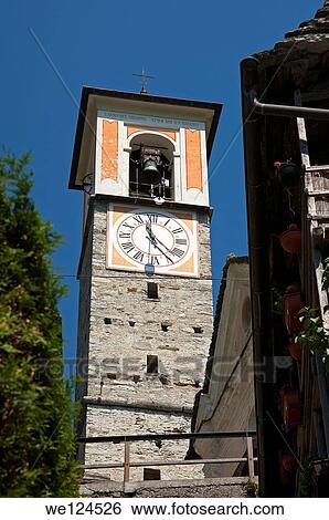 Stock Photograph - The clock tower of the parish church in the listed village of Corippo, the smallest municipality in Switzerland, Verzasca valley, Ticino, Switzerland.. Fotosearch