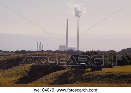A park bench casting shadows, with Poolbeg power station in the background View Large Photo Image Stock Photo - A park bench casting shadows, with Poolbeg power station in the background. Fotosearch