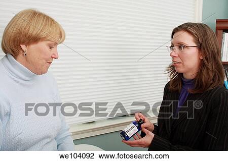 Aromatherapist shows bottle of medicine to patient View Large Photo Image Stock Image - Aromatherapist shows bottle of medicine to patient. Fotosearch