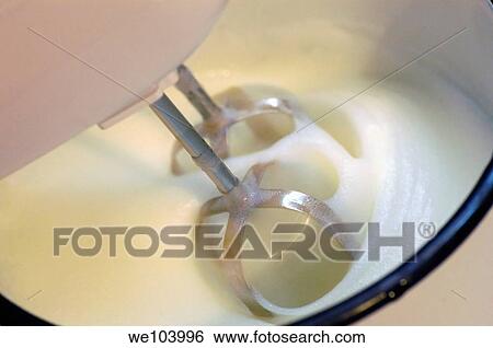 Beaters in a bowl in the process of whipping cream View Large Photo Image Stock Photograph - Beaters in a bowl in the process of whipping cream. Fotosearch