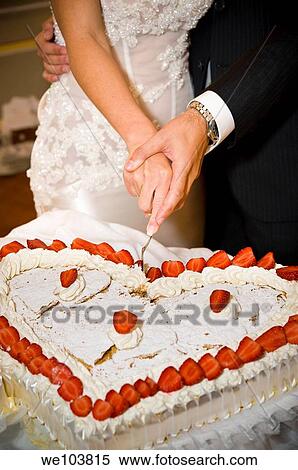 Bride and groom cutting a heart-shaped wedding cake View Large Photo Image Stock Photography - Bride and groom cutting a heart-shaped wedding cake. Fotosearch