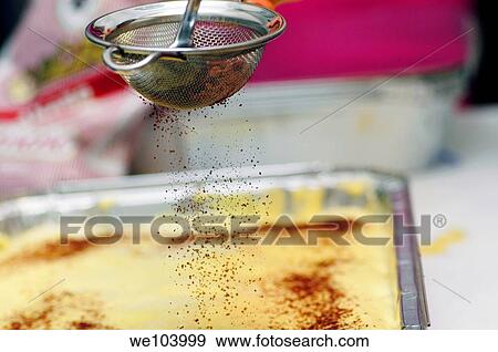 Chocolate powder sprinkled through a sieve on a cake View Large Photo Image Stock Photo - Chocolate powder sprinkled through a sieve on a cake. Fotosearch