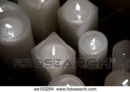 Close-up of lit white candles View Large Photo Image Picture - Close-up of lit white candles. Fotosearch