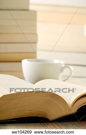 Stock Photo - Composition with harcover book and cup of coffee on the table. Fotosearch